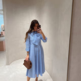 Vestido em popelina com riscas e laço à frente